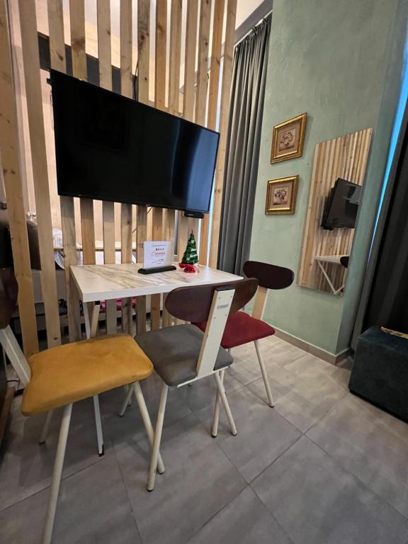 a living room with a table with a flat screen tv at Colombia Apartments&Rooms in Durrës