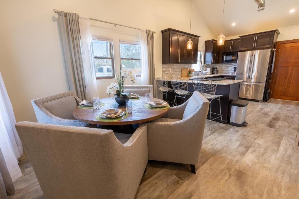 a kitchen and dining room with a table and chairs at Modern Luxury Bungalow steps from DT Activities in Rapid City