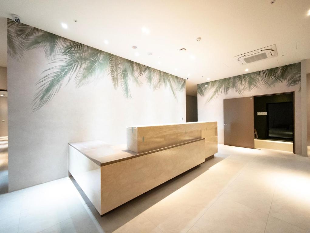 a lobby with a reception desk with a palm mural on the wall at 山島行旅 Hotel Sandao in Luodong