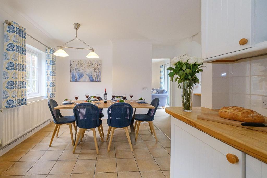 a kitchen and dining room with a table and chairs at Annie's House in Thorpeness