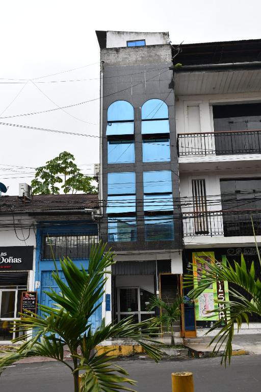 a building with a blue window on the side of it at SELVA VIVA IQUITOS in Iquitos