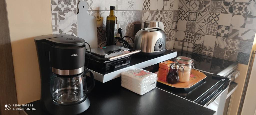 a coffee maker on a counter in a kitchen at Sofia's pottery house in Volos