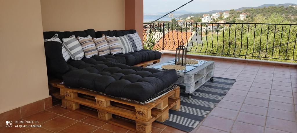 a living room with a couch and a balcony at Sofia's pottery house in Volos