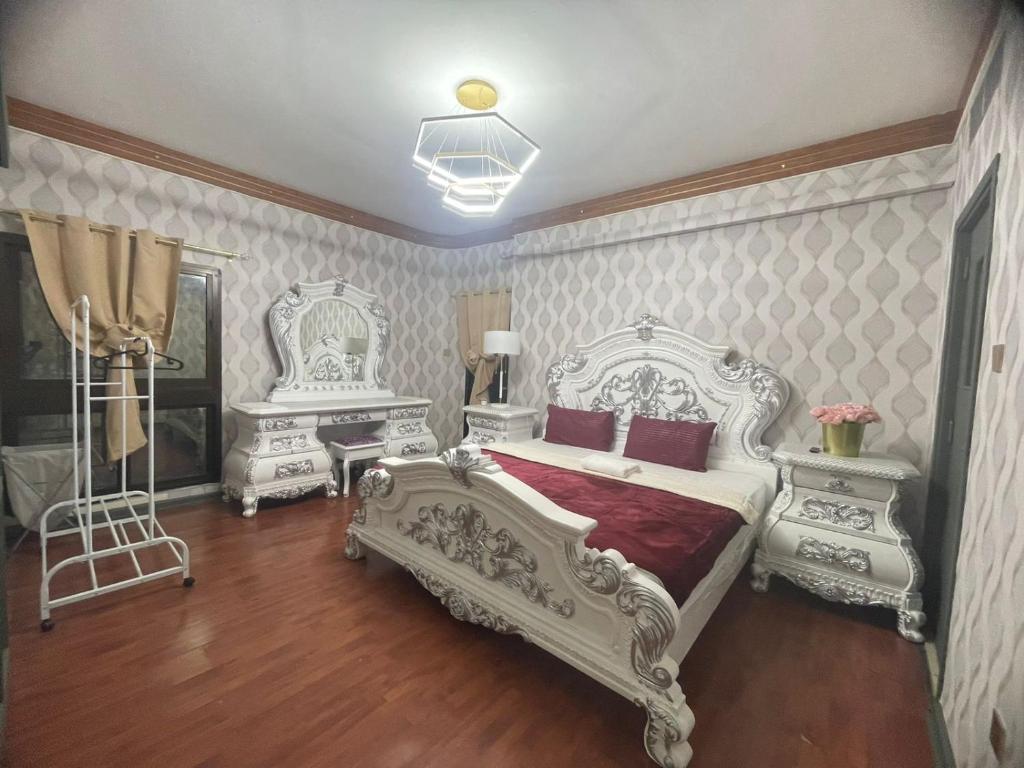 a bedroom with a white bed and two white consoles at Private Hall Room Bed Room and Washroom Room In Shared Apartment Flat 302-1 in Abu Dhabi