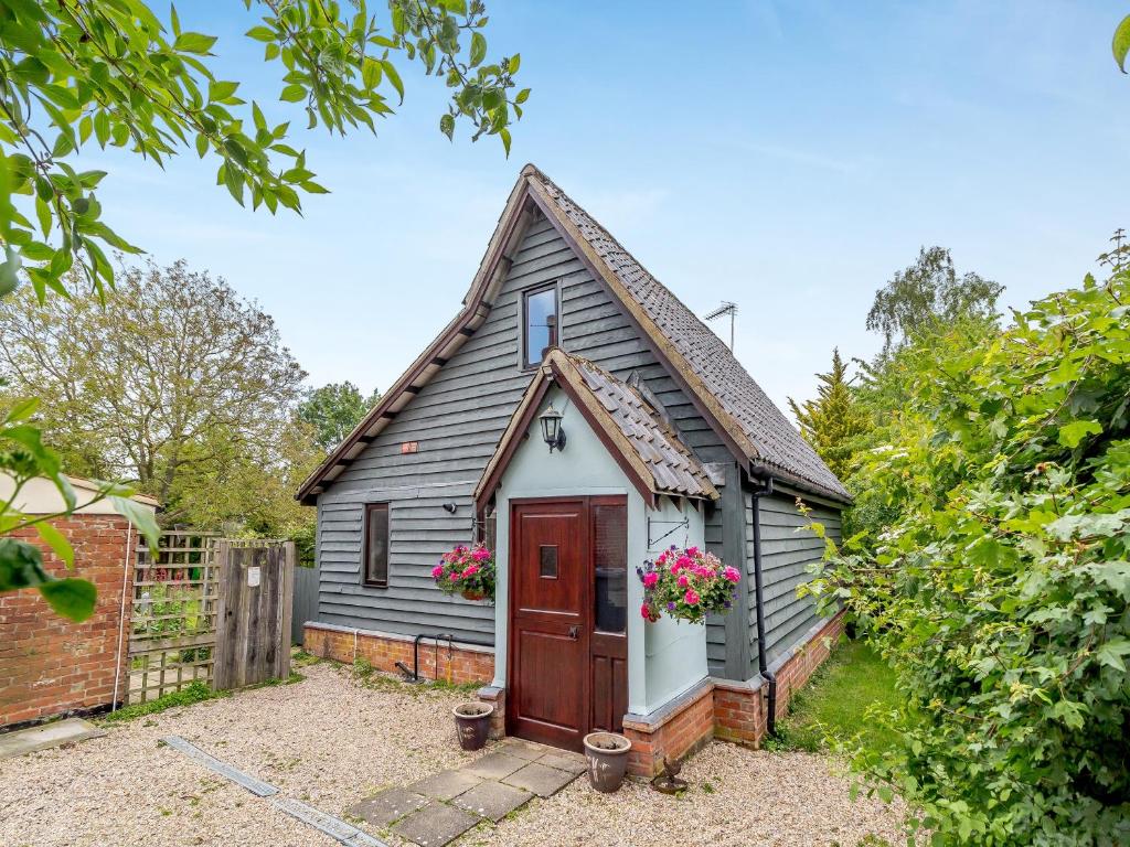 a small grey house with a red door at Bryanstown Annexe in Woodbridge