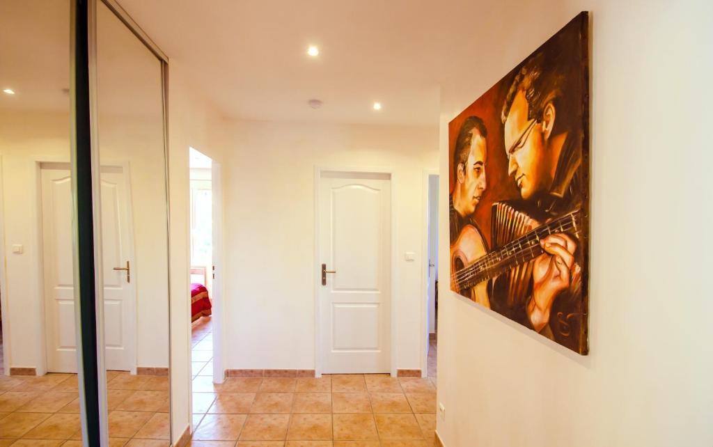 a large painting on a wall in a hallway at Grande Villa à Sainte Maxime - Golfe de Saint Tropez in Sainte-Maxime