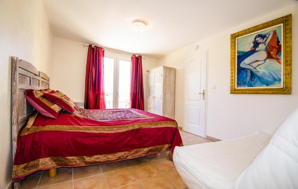 a bedroom with a bed and a painting on the wall at Grande Villa à Sainte Maxime - Golfe de Saint Tropez in Sainte-Maxime