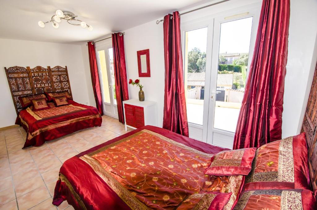 a bedroom with two beds and a window at Grande Villa à Sainte Maxime - Golfe de Saint Tropez in Sainte-Maxime