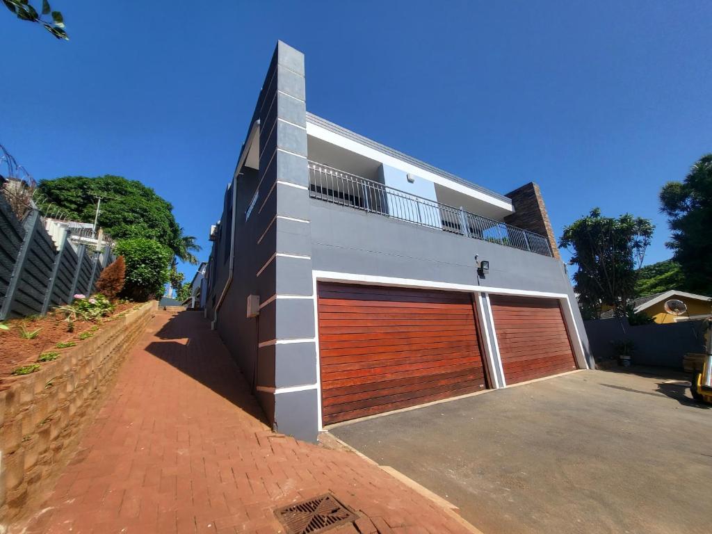a building with two garage doors on the side of it at Generosa of the North in Durban