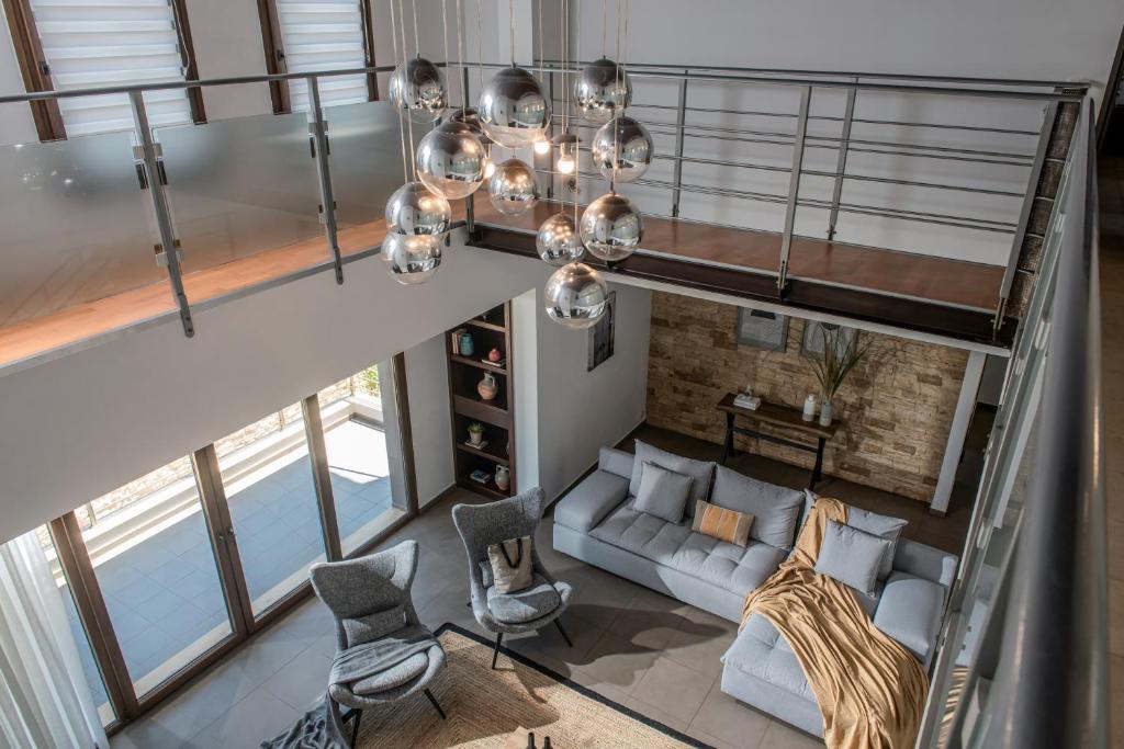 an overhead view of a living room with a couch and chairs at Villa Ete Premier Luxury Villa in Stalida