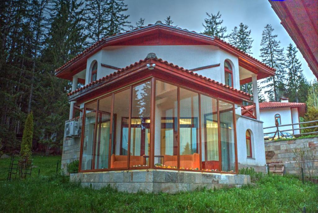 a small house with a lot of glass at Вила Capitalica Forte in Pamporovo