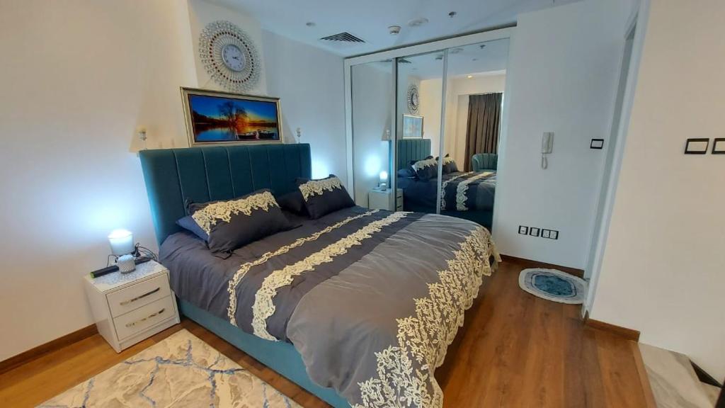 a bedroom with a large bed and a mirror at Furnished apartment in Damac Tower. Jordan in Amman