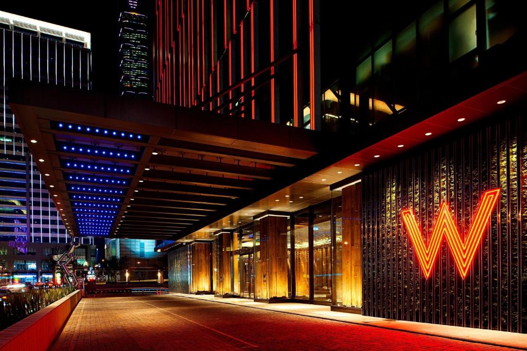 a building with aww sign on the side of it at night at W Taipei in Taipei