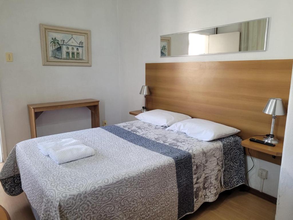 a bedroom with a bed with two pillows on it at Taufik Hotel in Rio Grande