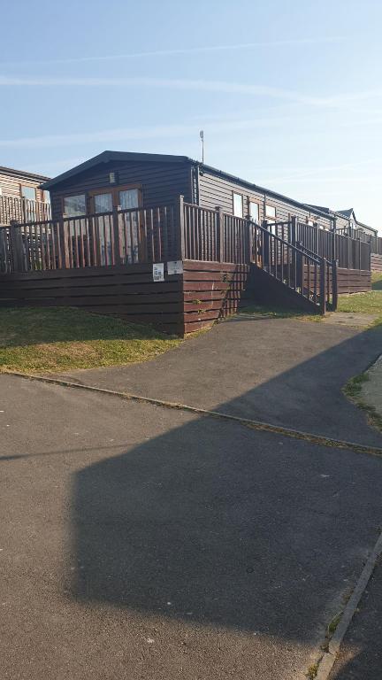 a building with a ramp leading up to it at Holiday Lodge, sleeps 4, with sea & countryside views in Ore