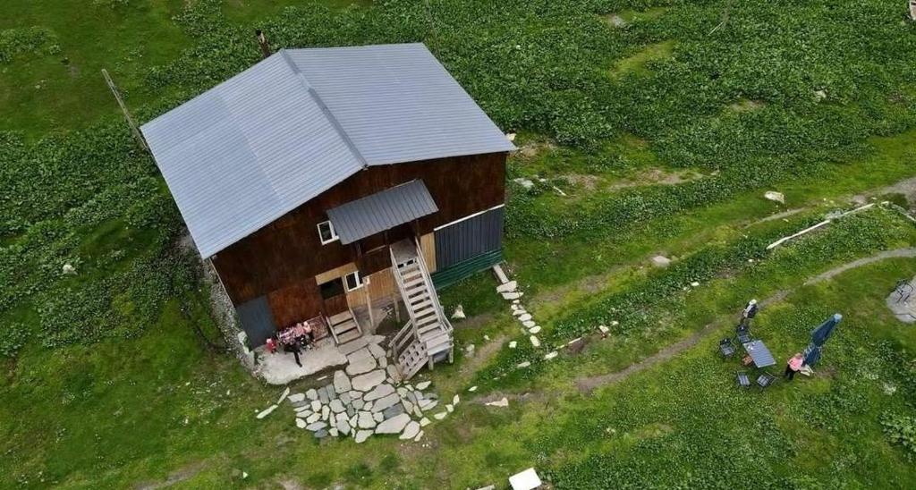 an aerial view of a small house in a field at Vila Latphari in Ushguli in Ushguli