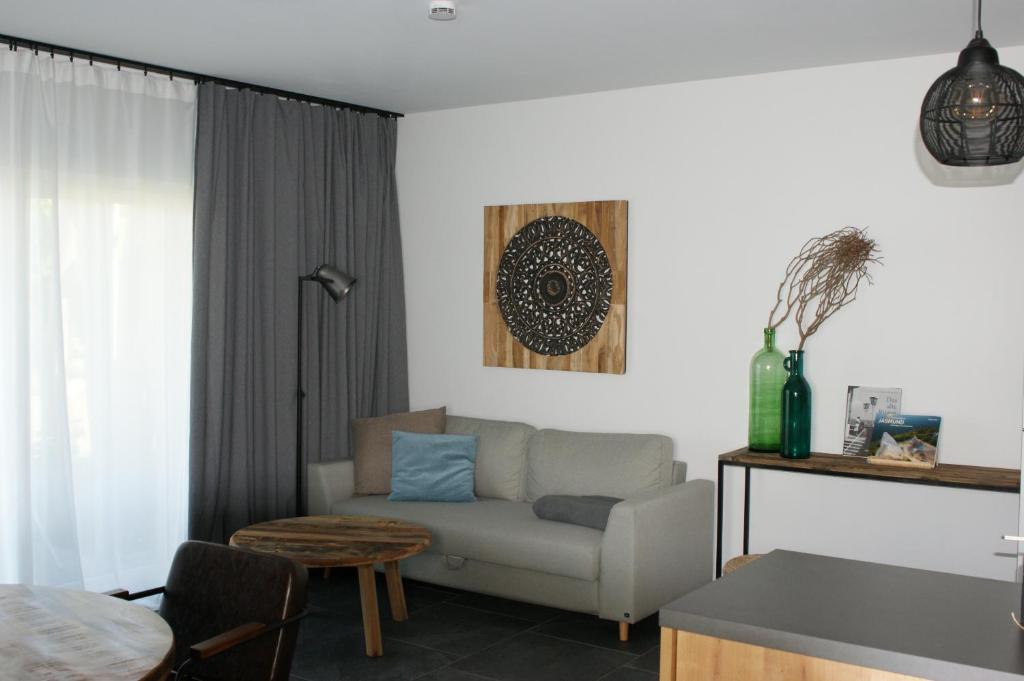 a living room with a couch and a table at Dock2Apartment Rügen Whg 1 große Terrasse, ruhige Lage in Lohme