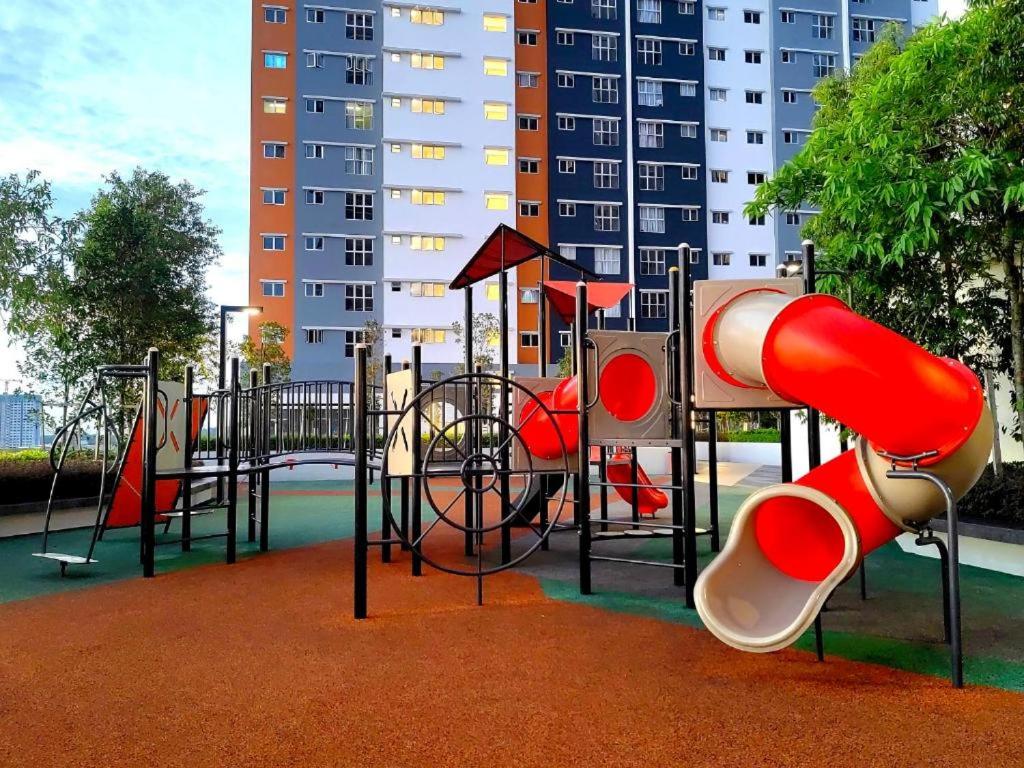 a playground with a slide in a park at Qilayna guest room in Sepang