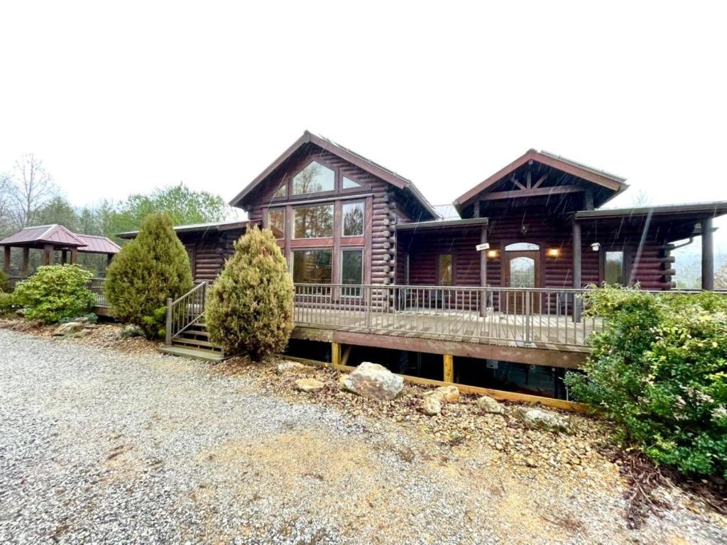a log cabin with a porch and a house at Grand View Home with 360 Degree Mountain View in Tellico Plains
