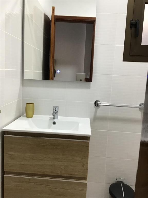 a bathroom with a sink and a mirror at Apartamentos Playamar in La Playa Calera