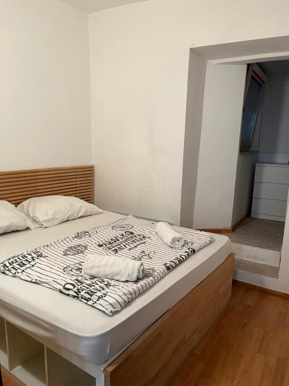 a bed with white sheets and towels on it at Apartment Nikolina in Piran