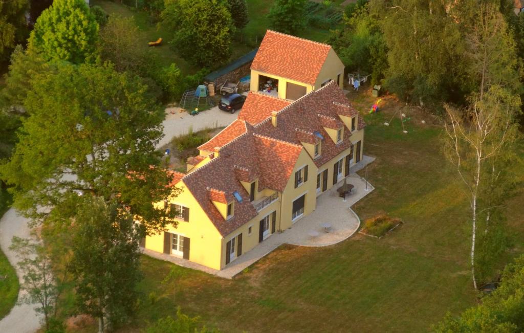 an overhead view of a large yellow house with orange roofs at La Foulerie in Bullion
