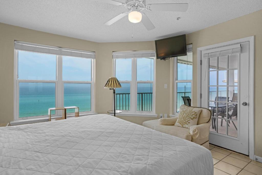 a bedroom with a bed and a view of the ocean at The Palms #601 in Fort Walton Beach