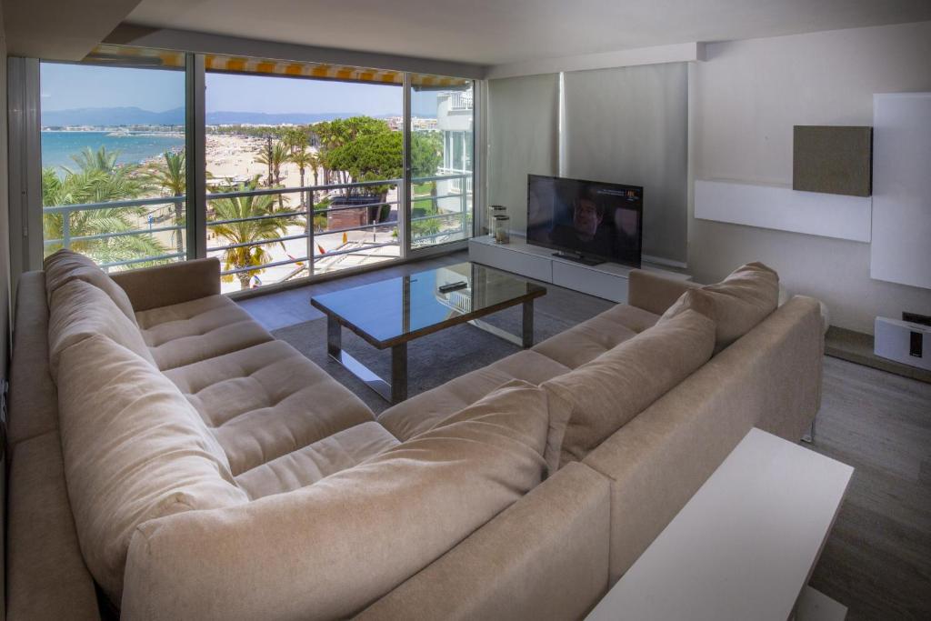 a living room with a large couch and a television at GLAM ONLY FAMILIES Planet Costa Dorada in Salou