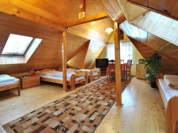 a room with a attic with a bed and a desk at DW Jastrun in Białka Tatrzanska