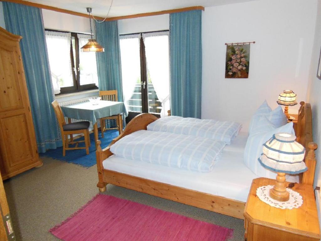 - une chambre avec un lit, une table et une fenêtre dans l'établissement Pension Haus Anne, à Bodenmais