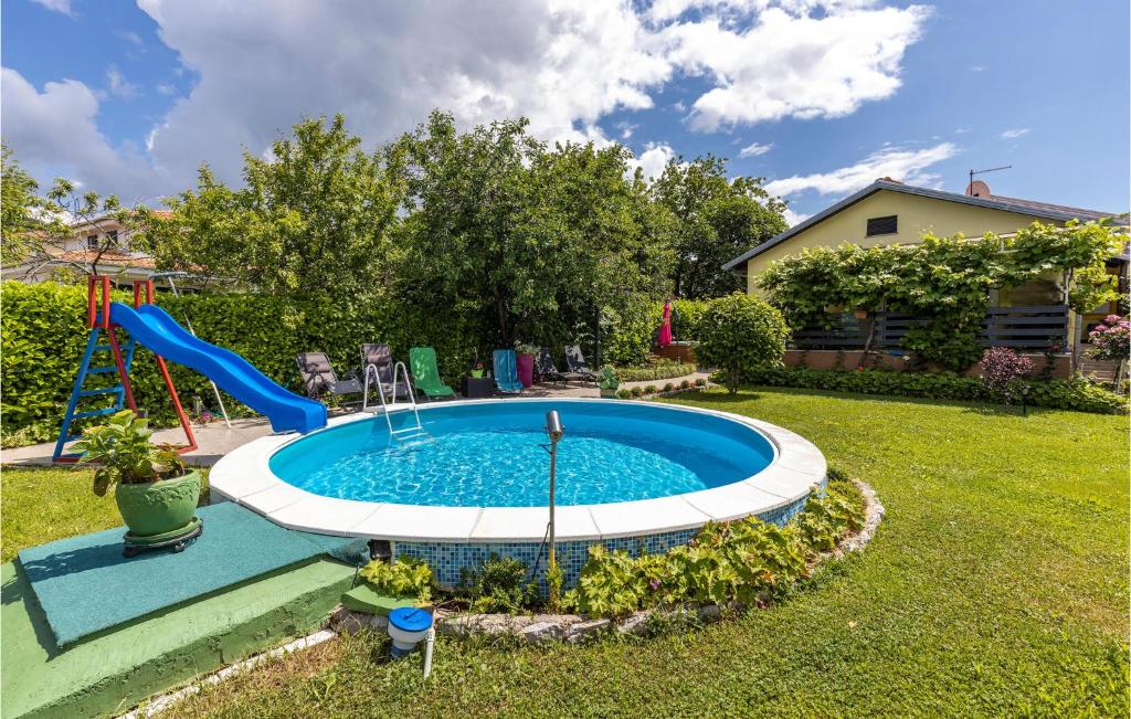a pool with a slide in a yard at 3 Bedroom Stunning Home In Kastav in Kastav