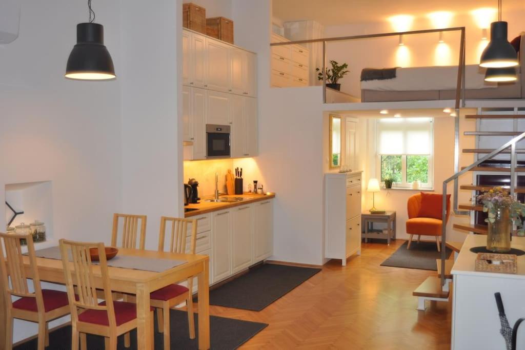 a kitchen and dining room with a table and chairs at Jane's Place in Ljubljana
