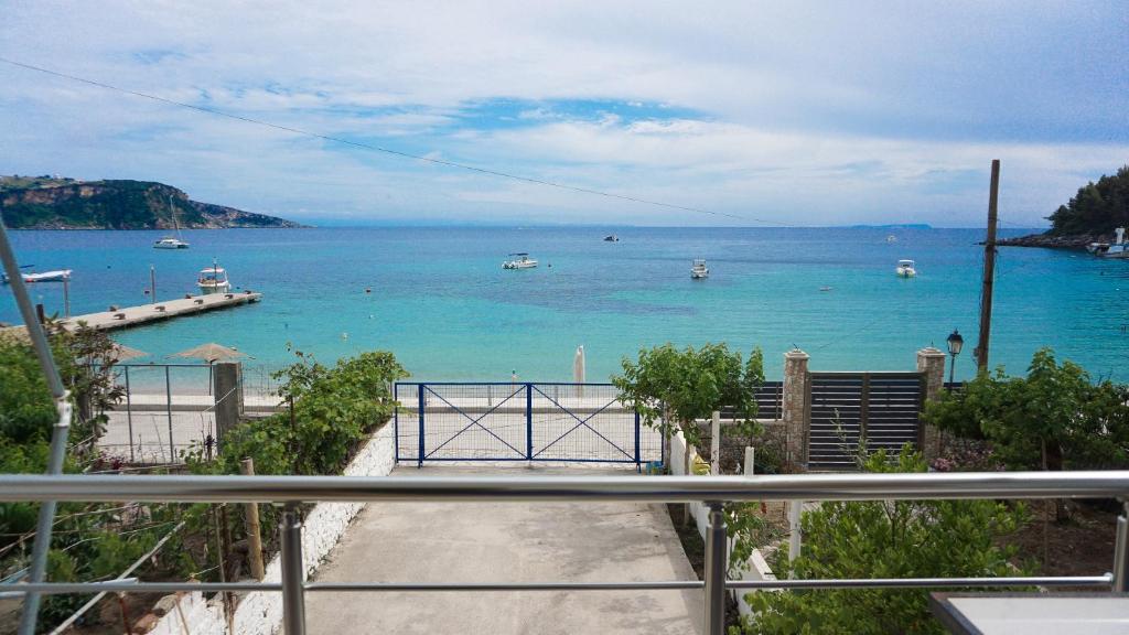 a view of the ocean with boats in the water at Joana‘s Rooms in Himare