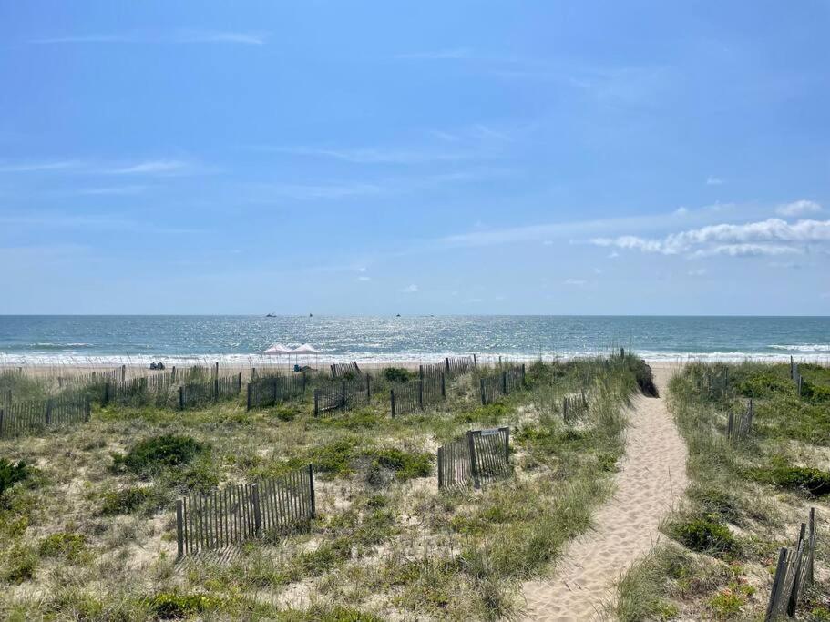 a dirt path leading to a beach with the ocean at The Lost Loggerhead- OBX Ocean view Beach House in Avon