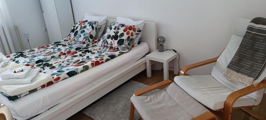 a bed in a room with a chair and a couch at Apartma 198 in Kranjska Gora
