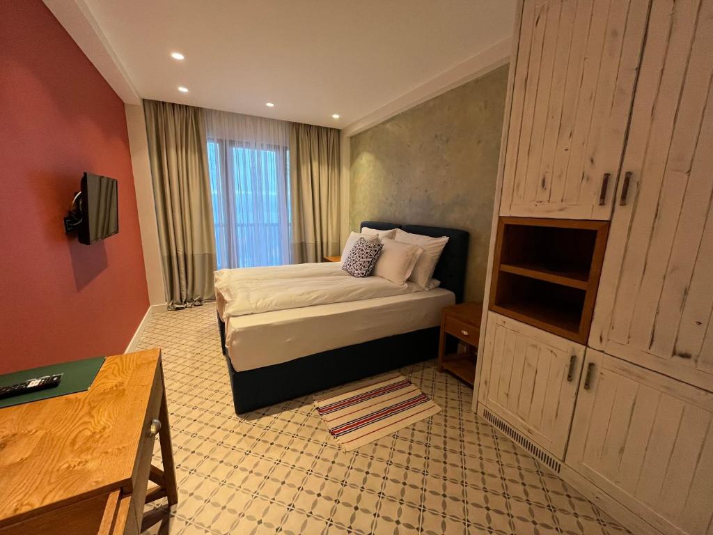 a hotel room with a bed and a cabinet at Vlasinsko jezero VILA BEST in Surdulica