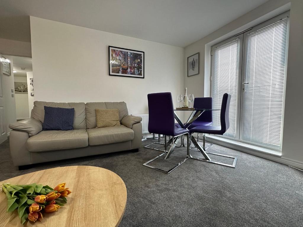 a living room with a couch and a table at Superb 2 bedroomed apartment in Great Oakley