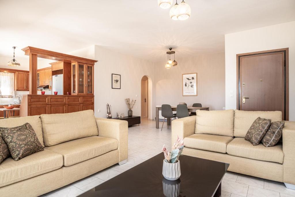 a living room with two couches and a table at Emily Apartment in Zakynthos Town