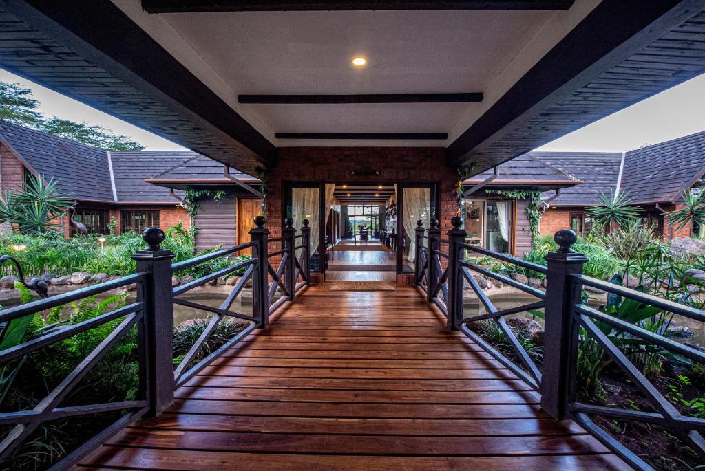 a wooden walkway leading to a house at The Retreat at Ngorongoro in Karatu