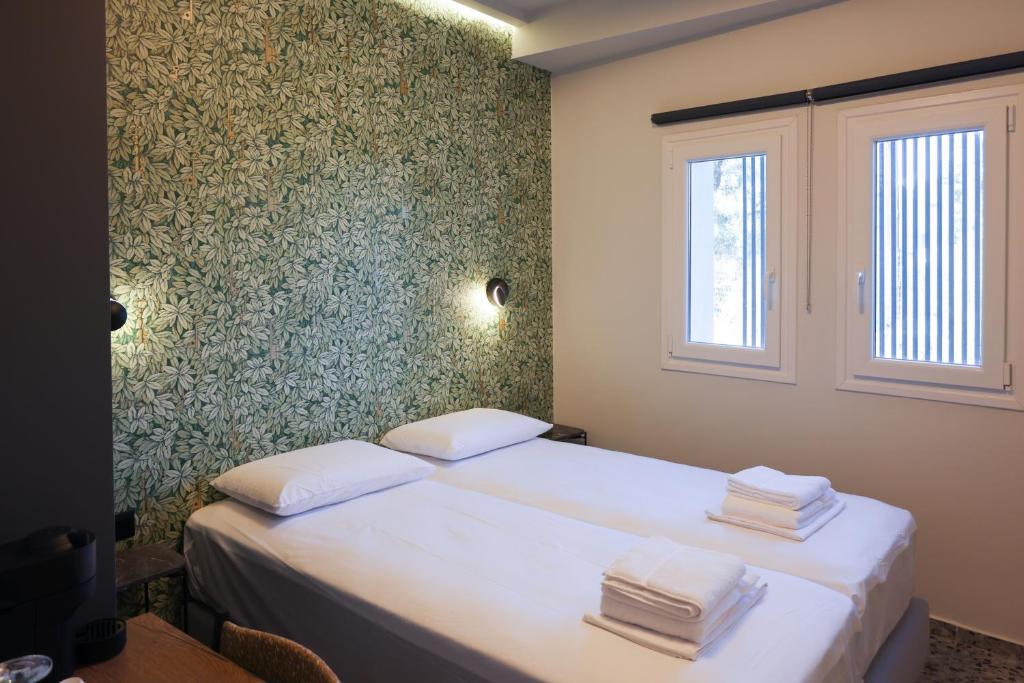 Postel nebo postele na pokoji v ubytování Uphill Unique Boutique Suites