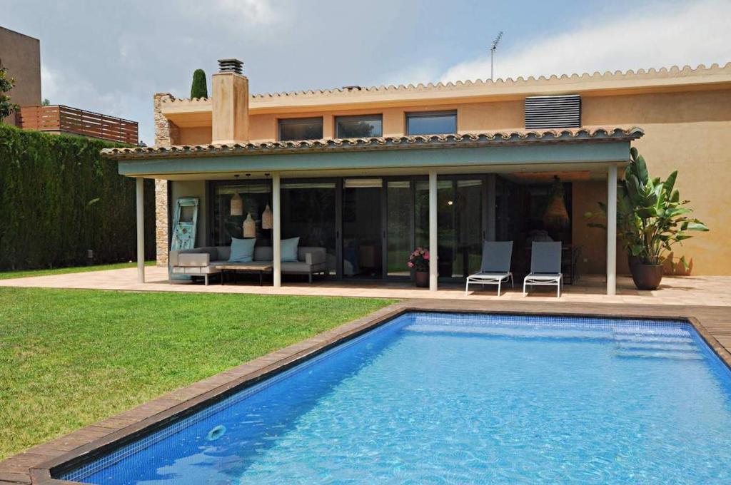 a swimming pool in front of a house at Villa Torrent Costa Brava, con piscina privada! in Pals