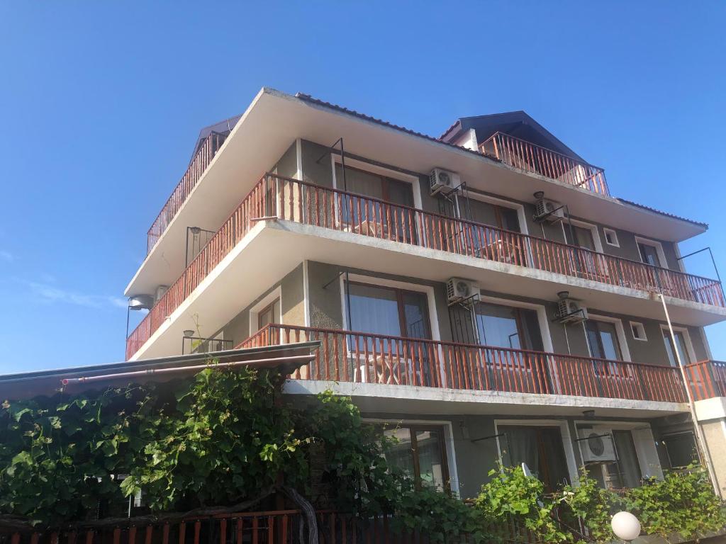 an apartment building with balconies on top of it at Stoyko's Guest House in Pomorie