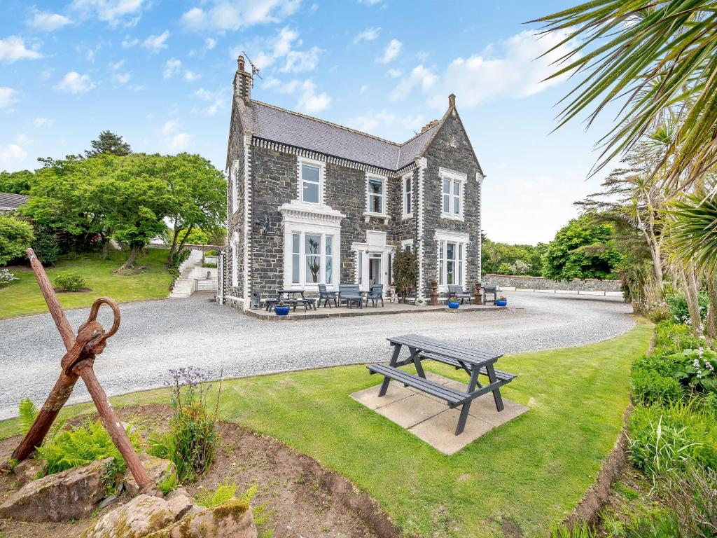 a house with a picnic table in front of it at Braefield in Portpatrick