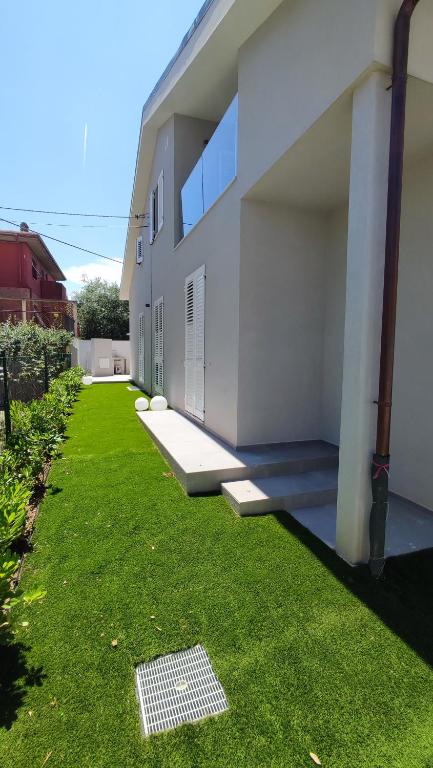 a house with a lawn in front of it at Casa Vacanze "Machí" in Senigallia