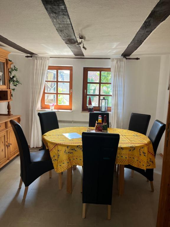 a dining room with a yellow table and chairs at Fachwerk in Bergfreiheit in Bad Wildungen