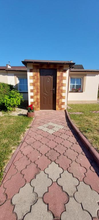 a walkway in front of a house at Domek Tomek in Wilkasy