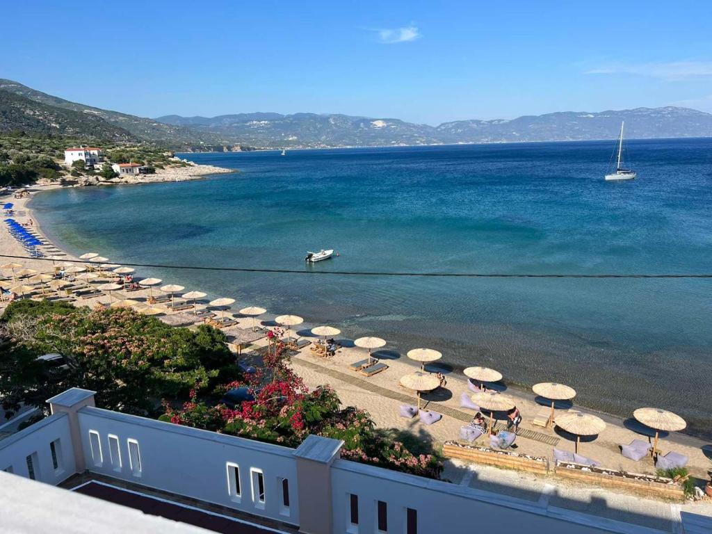 an aerial view of a beach with umbrellas and the ocean at Nereides Seaside Apartments in Marathokampos