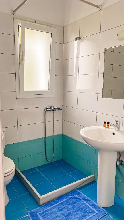 a bathroom with a shower and a sink at ELÉA Guesthouse himare in Himare
