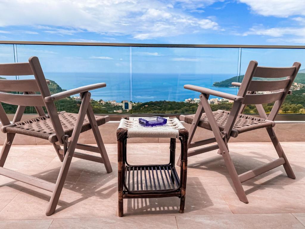 two chairs and a table on a balcony at ELÉA Guesthouse himare in Himare