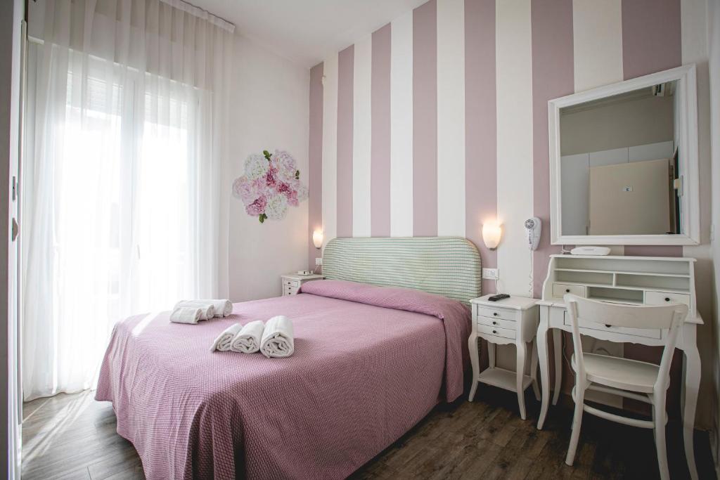 Postel nebo postele na pokoji v ubytování Hotel Ronchi